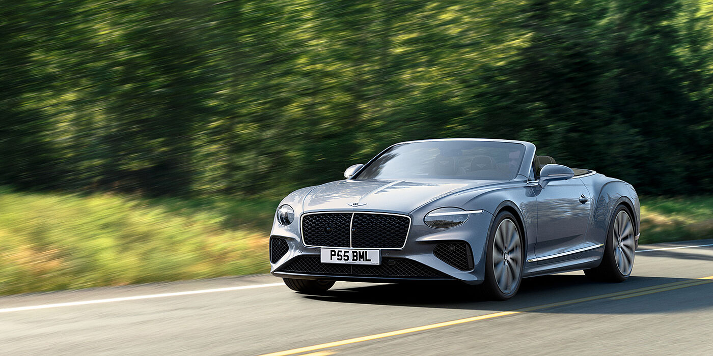 Bentley Johannesburg New Bentley Continental GTC convertible front view in Silverlake paint with 22 inch ten spoke wheels, driving dynamically on a country road