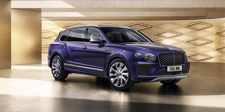 Bentley Johannesburg Bentley Bentayga Extended Wheelbase Mulliner SUV front three quarter in Tanzanite Purple paint with a gold patterned background