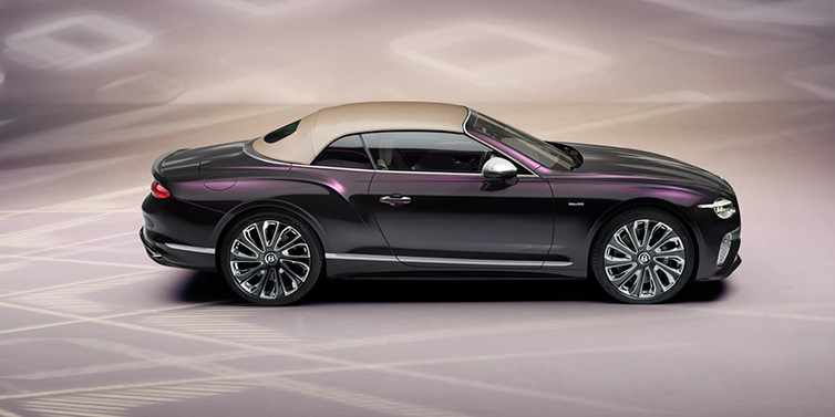 Bentley Johannesburg Bentley Continental GTC Mulliner convertible in profile with hood up, in Tanzanite Purple paint and 22 inch Mulliner painted and polished wheels