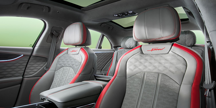 Bentley Johannesburg Bentley Flying Spur Speed sedan interior showing front and rear seats in Hotspur red and Gravity Grey hides, with Speed seat emblems