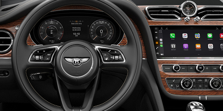 Bentley Johannesburg Bentley Bentayga SUV front interior detail of steering wheel and driver screens surrounded by Beluga black hide and Crown Cut Walnut veneer