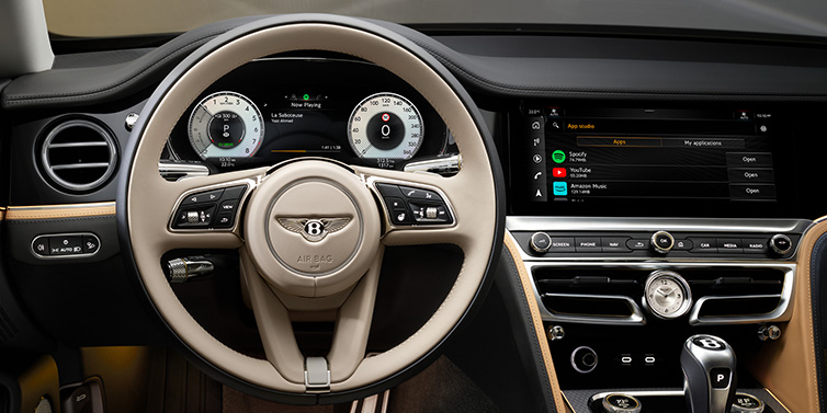 Bentley Johannesburg Bentley Flying Spur Mulliner sedan front interior detail of steering wheel and driver screens surrounded by Linen and Beluga black hides