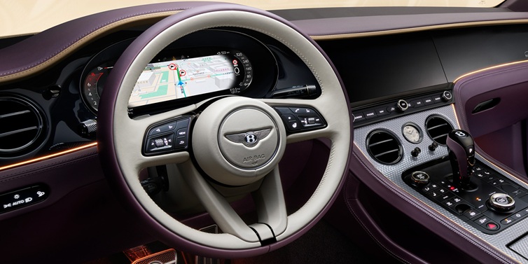 Bentley Johannesburg Bentley Continental GT Mulliner coupe front interior showing steering wheel and drivers screens surrounded by Linen and Damson hides and Grand Black veneer